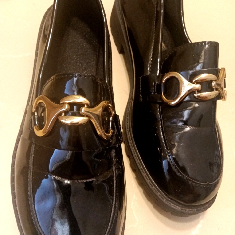 Black dress shoes with gold buckle